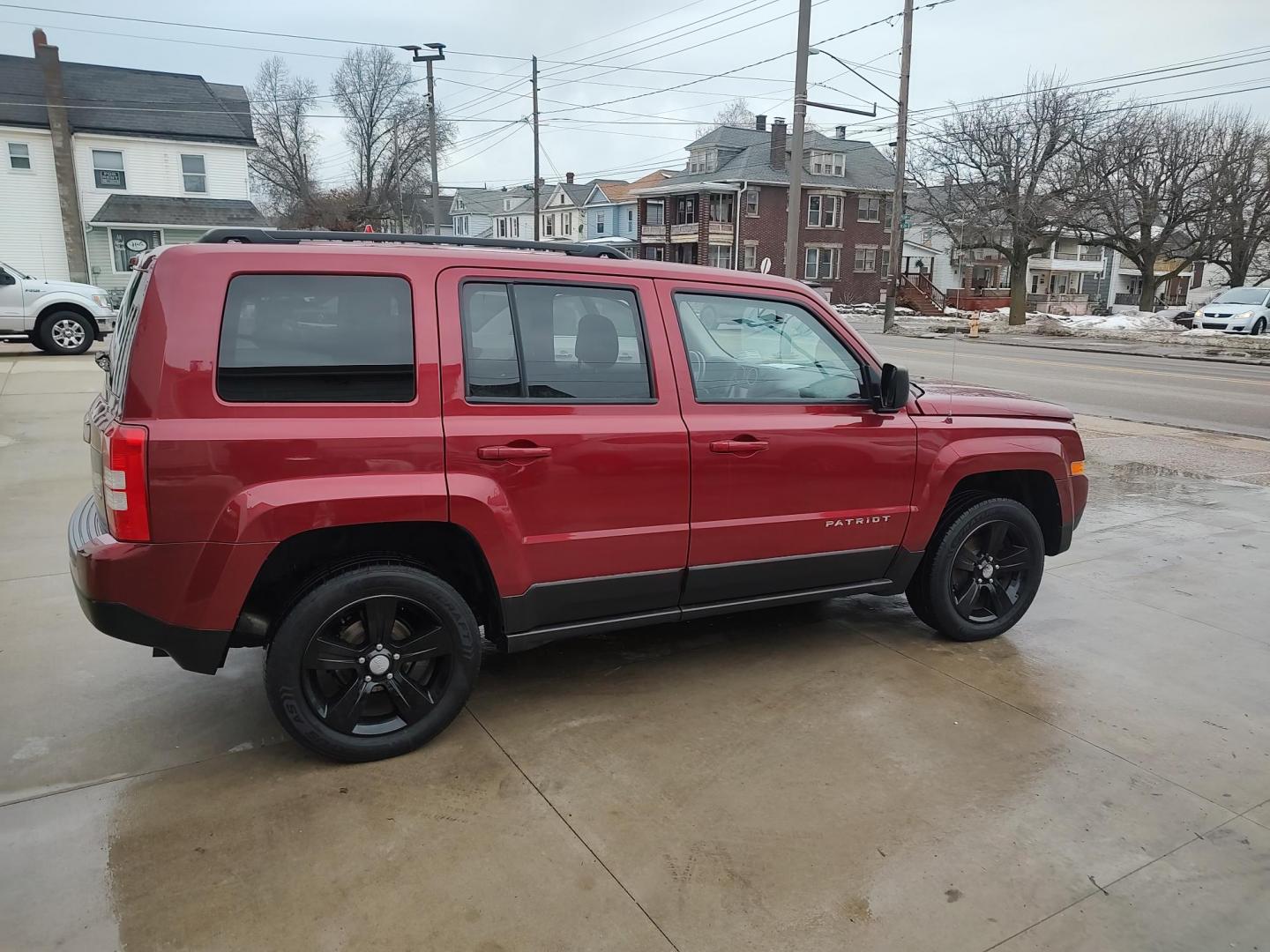 2014 Deep cherry Red Cyrstal Pearl Coat /Graphite Jeep Patriot Latitude 4WD (1C4NJRFB1ED) with an 2.4L L4 DOHC 16V engine, 4-Speed Automatic transmission, located at 827 W 26th Street, Erie, PA, 16508, (814) 455-3401, 42.105431, -80.090942 - Thanks for looking at our low mileage rust and accident-free new Jeep trade. This is the Latitude model with four-wheel drive, heated seats and lots more including a rust-free exterior as well as a like new nonsmoker interior. A full service was just done in our service department with new Pa state - Photo#2